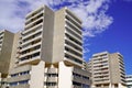 Building in city center with many windows against the blue sky and cloud Royalty Free Stock Photo