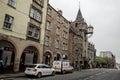 The building of the classical Tolbooth Tavern with a large clock above the Canongate street