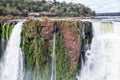 Building on a cliff over waterfall. Winter view of Iguazu Falls Devil's Throat under heavy clouds lead sky. Brazil.