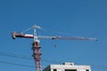 Building. Close-up of a construction crane against the blue sky Royalty Free Stock Photo