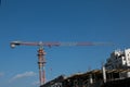 Building. Close-up of a construction crane against the blue sky Royalty Free Stock Photo