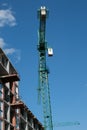 Building. Close-up of a construction crane against the blue sky Royalty Free Stock Photo