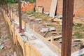 Building concrete foundation for new fence. House fence construction site during concrete pouring slabs works with formwork Royalty Free Stock Photo