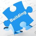 Building construction concept: Building on puzzle background Royalty Free Stock Photo