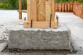 Building construction concept. Close up photo of house support element with wooden column and concrete formwork against red brick