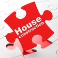 Building construction concept: House Construction on puzzle background Royalty Free Stock Photo