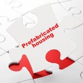 Building construction concept: Prefabricated Housing on puzzle background Royalty Free Stock Photo