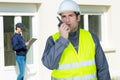 Building construction foreman giving order through walkietalkie