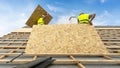 Building construction process of new wooden roof on wood frame house Royalty Free Stock Photo