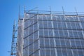 Building construction with scaffolding, blue sky background