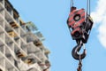 Building construction site - crane hook against blue sky Royalty Free Stock Photo