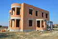 Building & Construction Site in Progress to New Red Brick House Exterior. Royalty Free Stock Photo