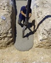 Building construction worker pouring cement