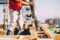 Building construction worker pouring cement or concrete with pump tube Royalty Free Stock Photo