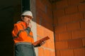 Building contractor and construction engineer making sketches and writing notes on building site Royalty Free Stock Photo