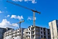 Building crane on the background of blue sky