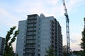 Building crane and building under construction. Construction site. Construction cranes and high rise building under Royalty Free Stock Photo