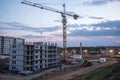 Building crane and buildings under construction against evening sky Royalty Free Stock Photo