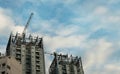 Building crane and buildings under construction and cloudy sky,copy space