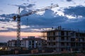 Building crane and construction site against evening sky Royalty Free Stock Photo