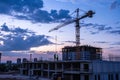 Building crane and construction site against evening sky Royalty Free Stock Photo