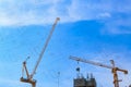 Building crane and construction site under blue sky with drawing Royalty Free Stock Photo