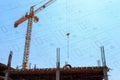 Building crane and construction site under blue sky with drawing Royalty Free Stock Photo