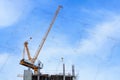 Building crane and construction site under blue sky with drawing Royalty Free Stock Photo