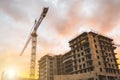 Building crane at sunset and building an orange sky. Royalty Free Stock Photo