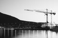 Building cranes in evening Tromso background Royalty Free Stock Photo