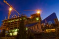 Building cranes and onstruction site at night Royalty Free Stock Photo