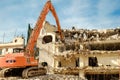 Building demolition with hydraulic excavator Royalty Free Stock Photo