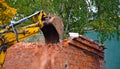 Building demolition with hydraulic excavator