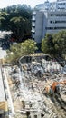 Building demolition site with an orange tractor beside Royalty Free Stock Photo