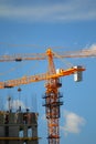 Building with elevating cranes Royalty Free Stock Photo
