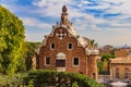 Building at the entrance of the Antoni Gaudi Park Guell in Barcelona, Spain with the view of the city skyline in the background Royalty Free Stock Photo