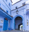 Semicircular arch, in Arabic style, on the blue painted street in the medina of Chefchaouen, Morocco