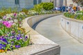 Building exterior with lush trees and colorful flowers on a sunny spring day Royalty Free Stock Photo