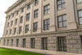 Building facade with decorative mouldings on the white stone exterior wall Royalty Free Stock Photo