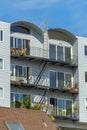 Building facade with exterior fire escape ladders for saftey with black painted metal on white timber house Royalty Free Stock Photo