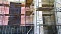Building facade renovation. Construction site with scaffolding. Restoration of ancient house. Columns repairing. Reconstruction. R