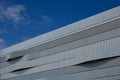 Building facade ribbed metal siding on modern building. horizontal stripes. blue sky Royalty Free Stock Photo