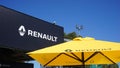 Building facade signboard and branded yellow umbrella with logo close-up of Renault dealership Royalty Free Stock Photo