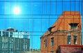 Building facade  Sun  Reflection modern  and old vintage house blue Windows  glass and stone of front house wall Skyscraper  wall Royalty Free Stock Photo