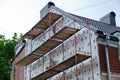 Building facade under renovation works with construction scaffolding frame. Wall insulation with styrofoam sheets for Royalty Free Stock Photo