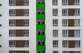 Building facade with windows and green balconies. Flat view pattern. Modern urban architecture background. Mortgage to buy private Royalty Free Stock Photo