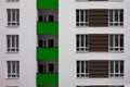 Building facade with windows and green balconies. Flat view pattern. Modern urban architecture background. Mortgage to buy private Royalty Free Stock Photo