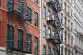 Building facades with fire escape stairs in New York Royalty Free Stock Photo
