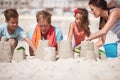 Building a family castle. a happy family building sandcastles together at the beach. Royalty Free Stock Photo