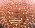 Building, fisheye and closeup of red, brick wall for texture, background and pattern of exterior structure. Architecture Royalty Free Stock Photo